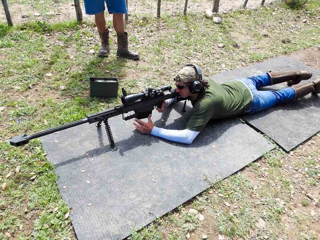 A U.S. paratrooper scans for targets behind a Barrett .50-caliber sniper  rifle while on a